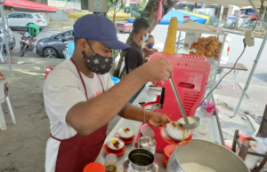 Indian man selling ice dessert